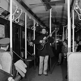 Woody Guthrie Performs In Subway Car by Eric Schaal