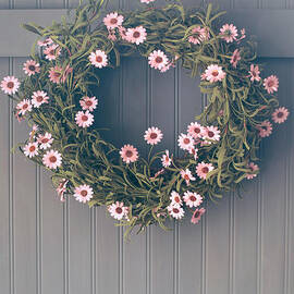 Spring wreath with flowers hanging on hook by Sandra Cunningham